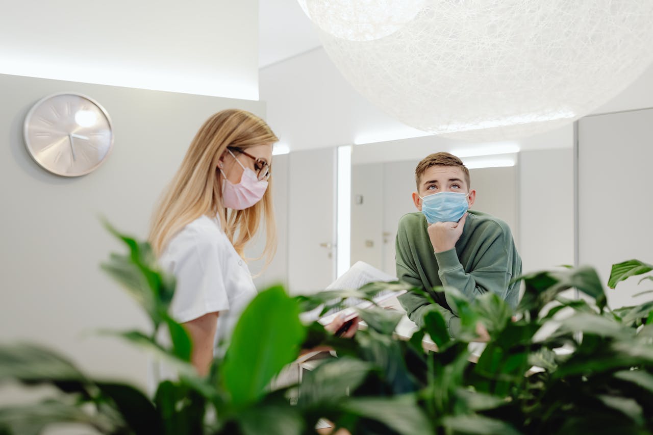Nurse and patient wearing face masks in a modern clinic, enhancing safety.